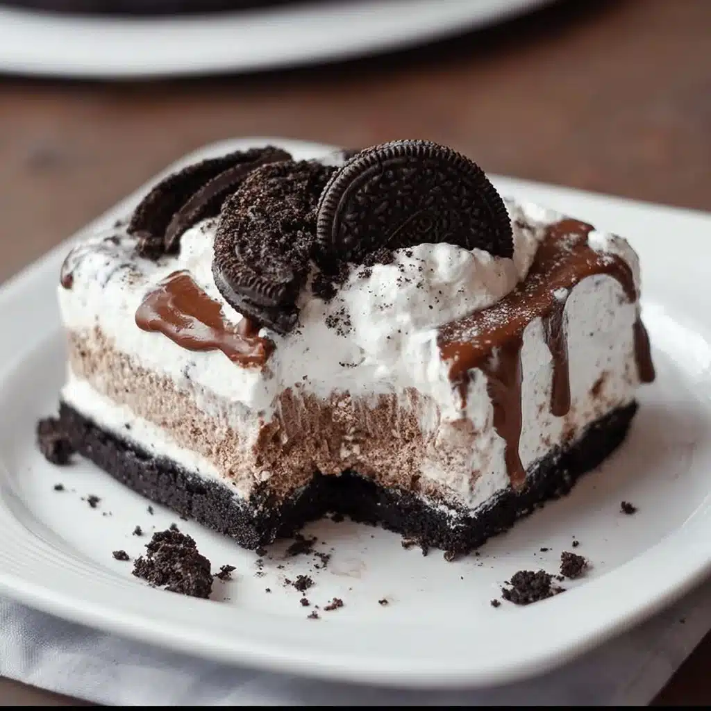 Delicious Oreo Ice Cream Cake topped with crushed Oreos and whipped cream