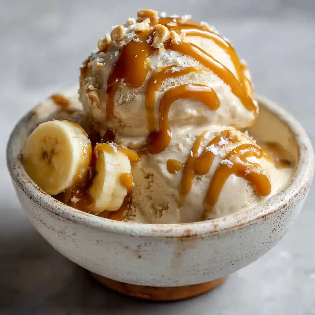 Bowl of Peanut Butter Banana Nice Cream garnished with banana slices and nuts